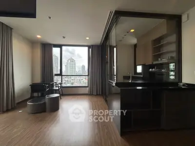 Modern open-layout kitchen with city view in luxury apartment