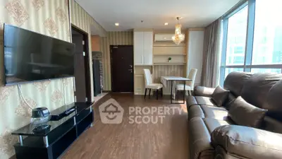 Spacious living room with elegant decor and large windows offering natural light.