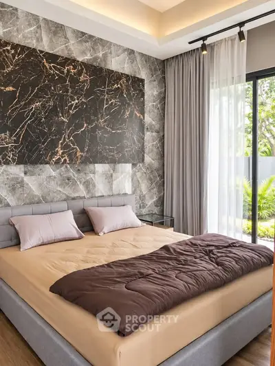 Luxurious bedroom with modern decor and large window overlooking garden