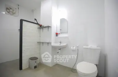 Spacious modern bathroom with sleek white fixtures and minimalist design