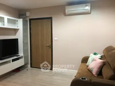 Cozy living room with modern TV setup and comfortable seating