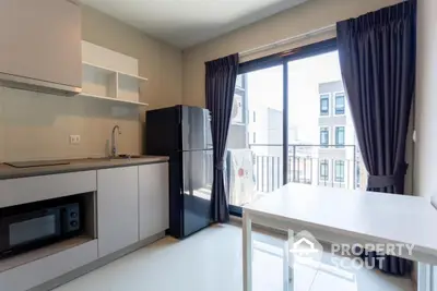 Modern kitchen with sleek appliances and balcony view in a stylish apartment