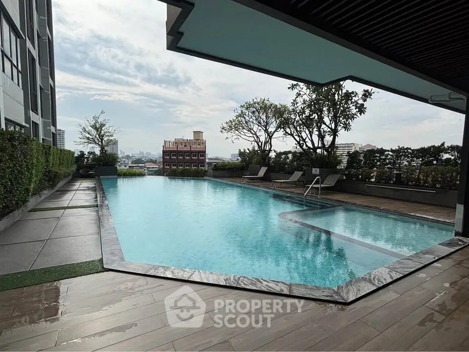 Luxurious rooftop pool with city view and lounging area
