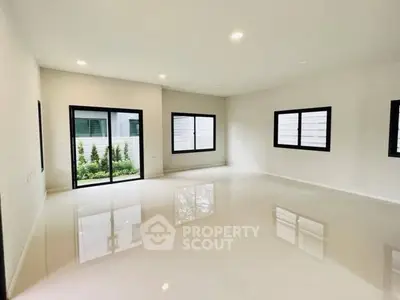Spacious modern living room with large windows and garden view