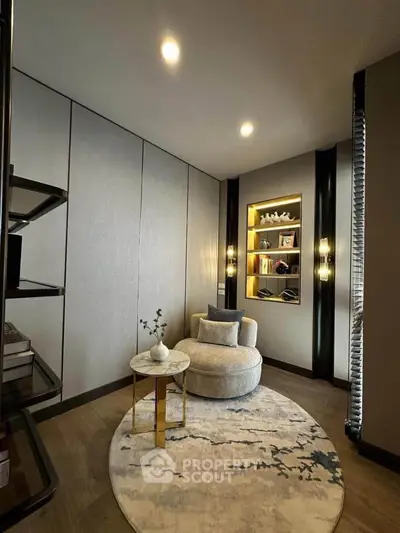 Elegant study room with modern decor and cozy seating area, perfect for work or relaxation.