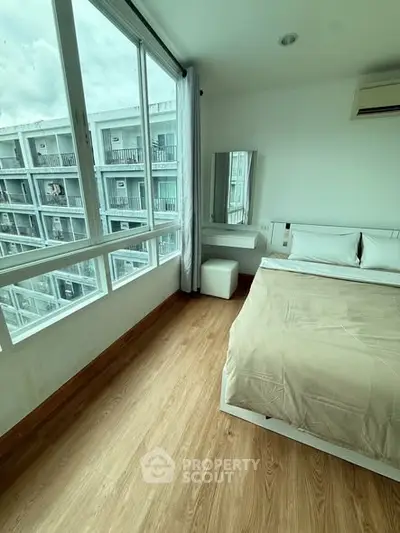 Bright bedroom with large windows and modern decor in urban apartment