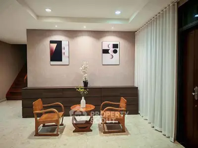 Elegant modern living room with stylish furniture and abstract art, perfect for contemporary home buyers.