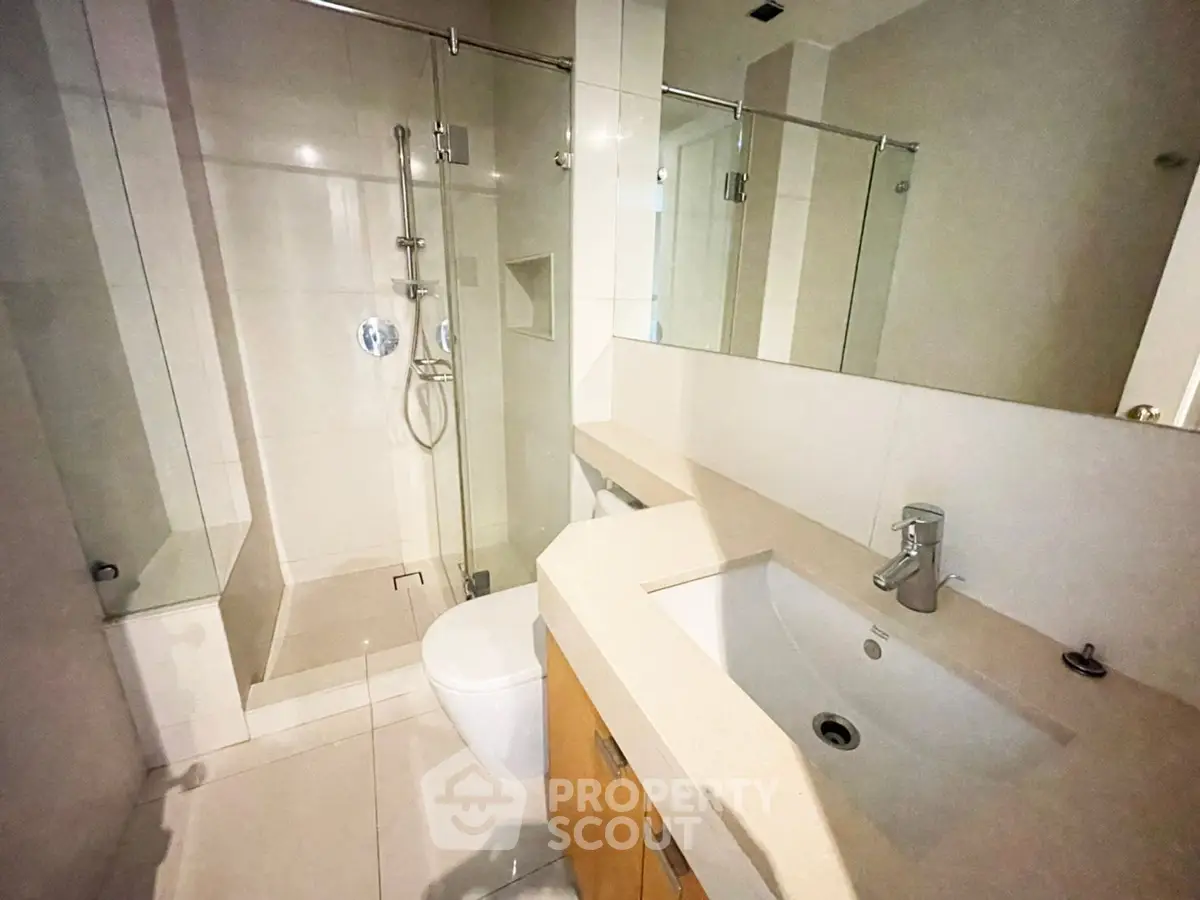 Modern bathroom with sleek fixtures and glass shower enclosure
