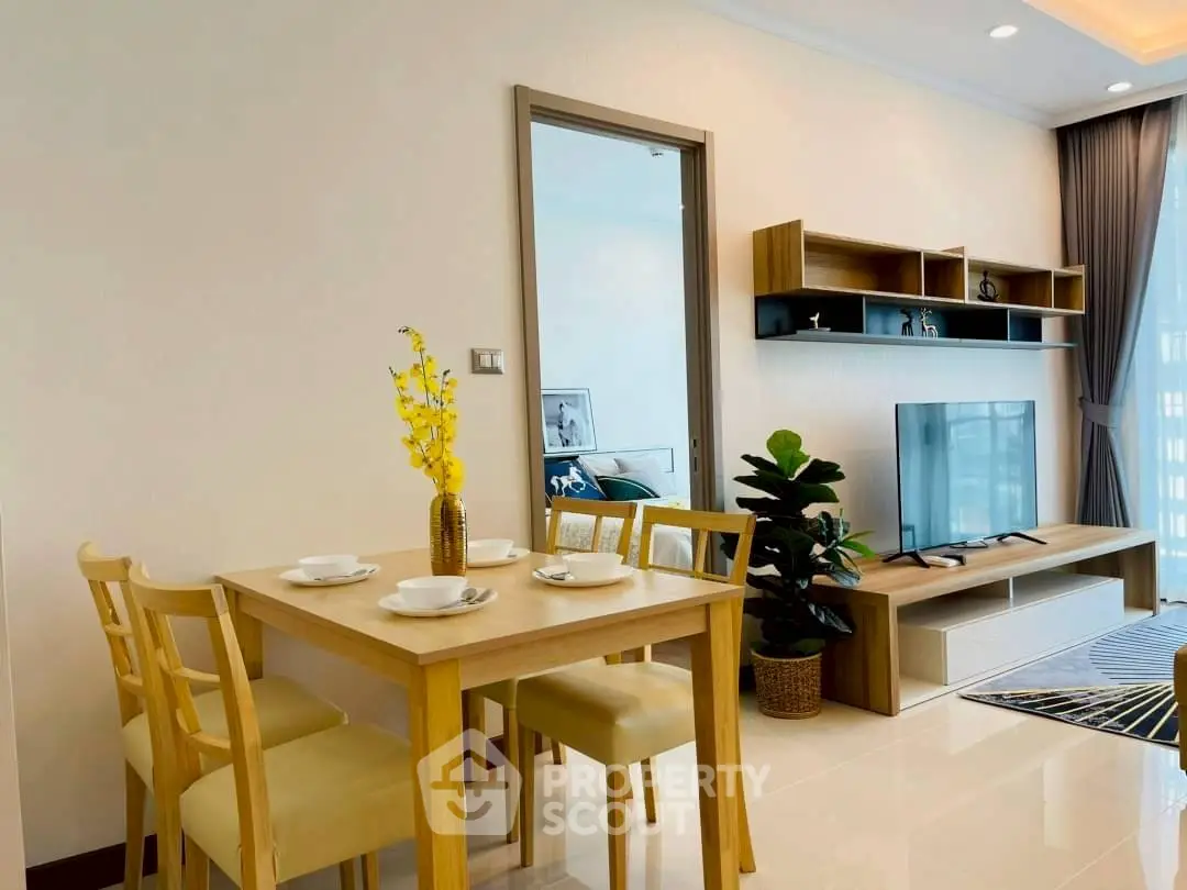 Modern living room with dining area, stylish furniture, and natural light.