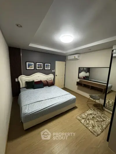 Cozy bedroom with modern decor, featuring a plush bed, stylish wall art, and ambient lighting.