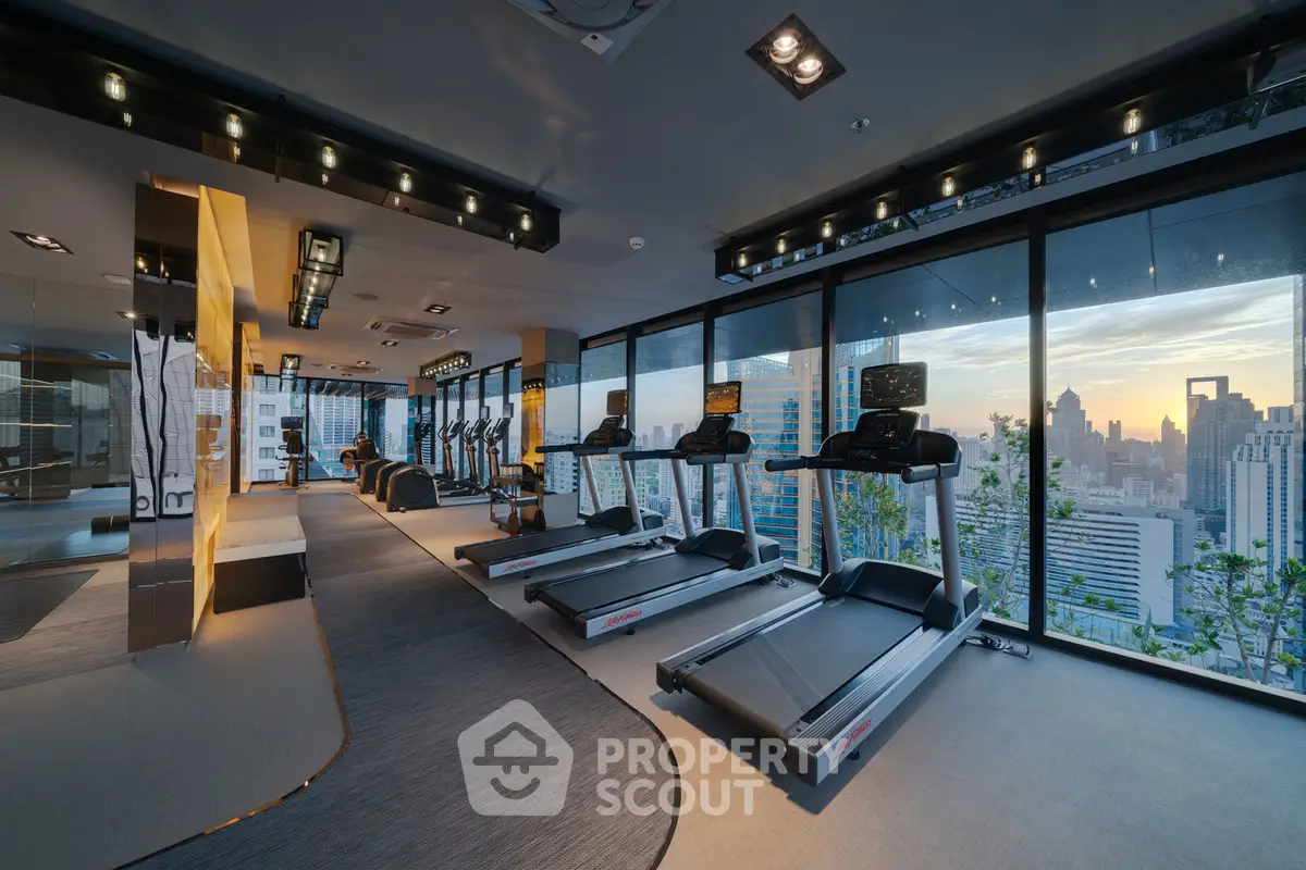 Luxurious high-rise gym with panoramic city views and modern fitness equipment.