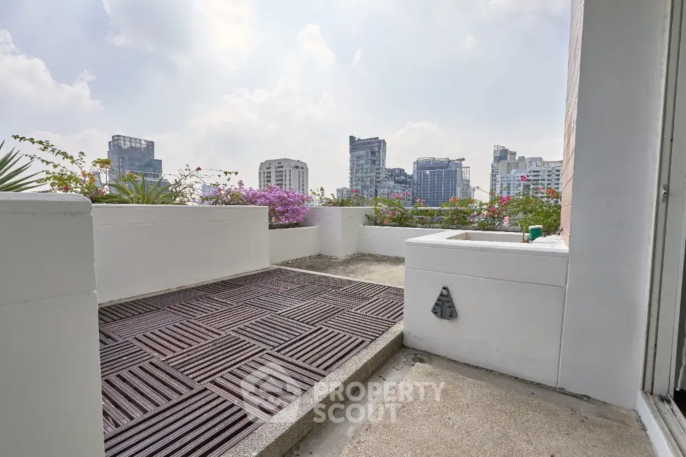 Stunning rooftop terrace with city skyline views and lush greenery