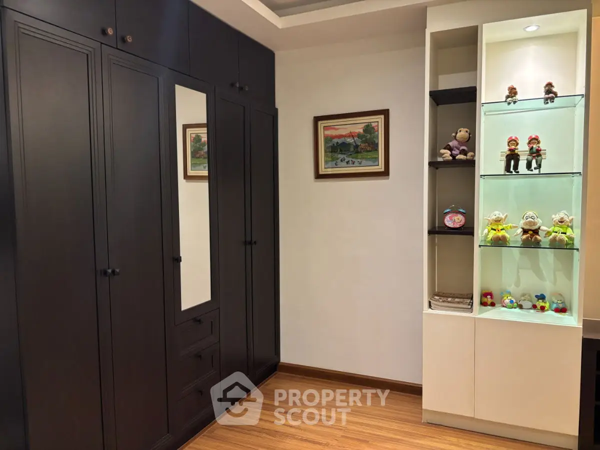 Stylish bedroom with dark wood wardrobe and decorative shelves