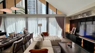 Luxurious modern living room with high ceilings and large windows offering stunning city views.