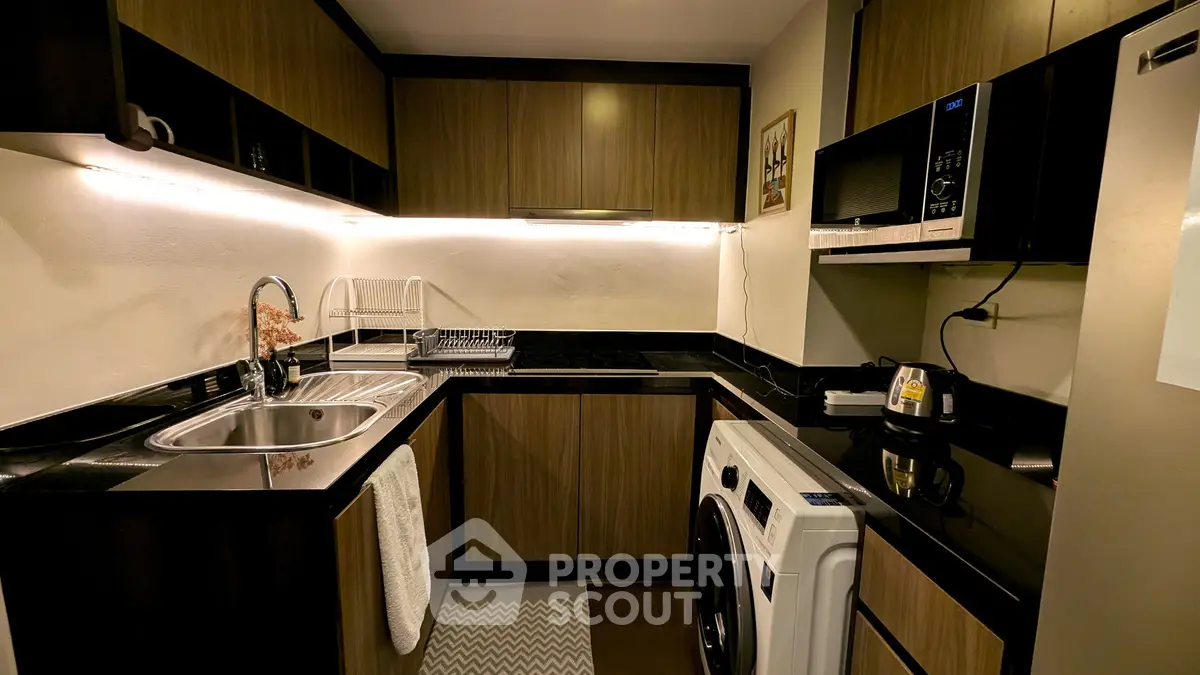 Modern kitchen with sleek black countertops and built-in appliances