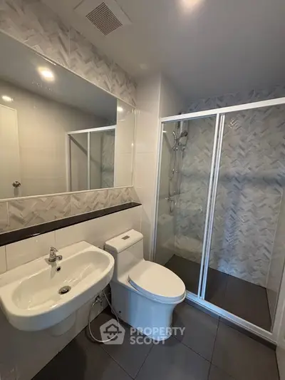 Modern bathroom with sleek shower and elegant fixtures