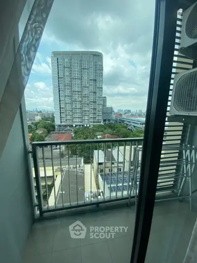 Spacious balcony with stunning city view in modern high-rise apartment