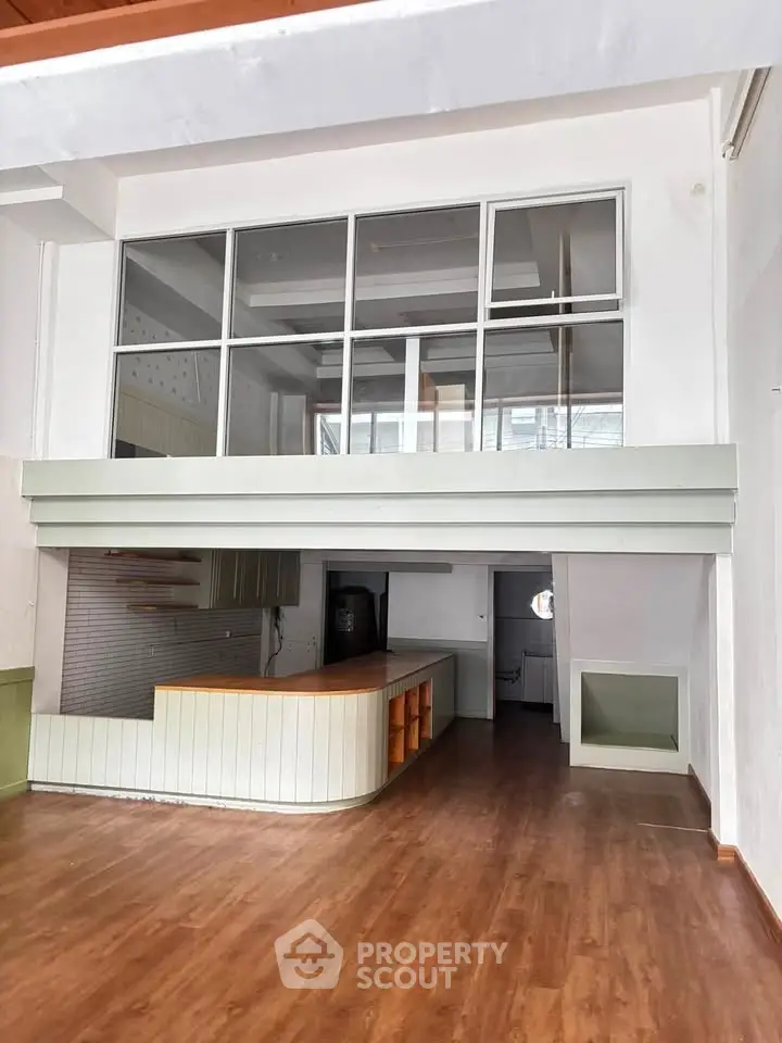 Spacious open-plan living area with mezzanine and modern wooden flooring