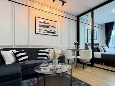 Modern living room with stylish decor and open layout, featuring a cozy seating area and elegant dining space.