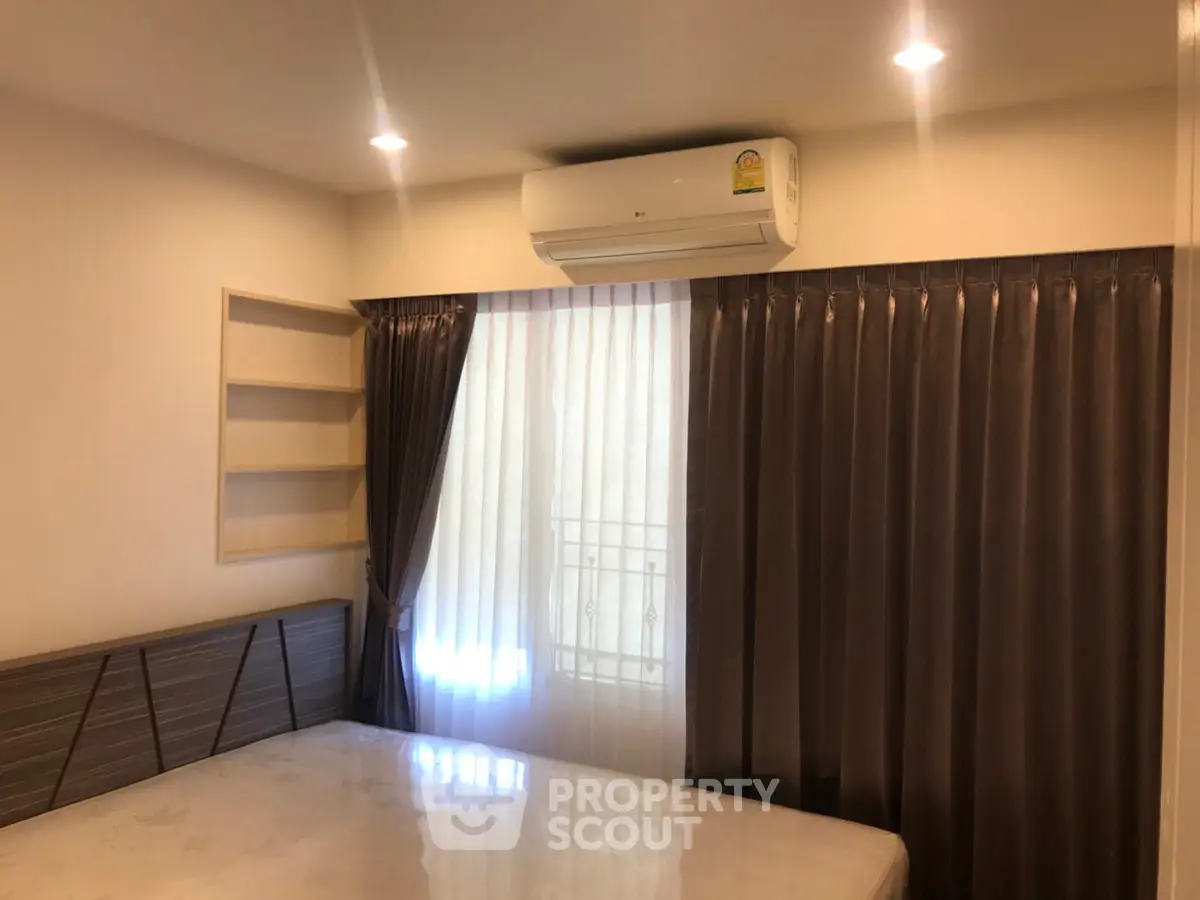 Cozy bedroom with air conditioning and elegant curtains, perfect for restful nights.