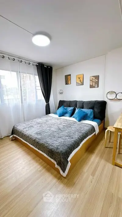 Cozy bedroom with modern decor and large windows for natural light