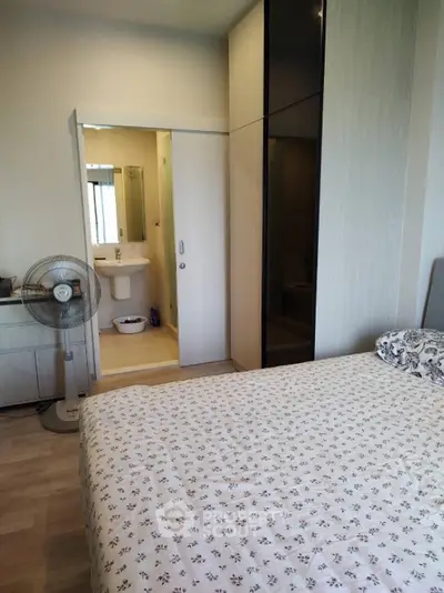 Cozy bedroom with ensuite bathroom and modern wardrobe in stylish apartment