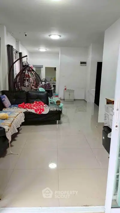 Spacious living room with modern furniture and glossy tiled flooring