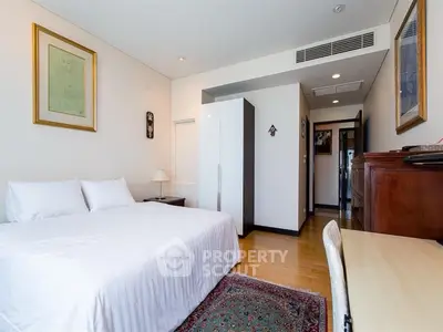 Spacious bedroom with elegant decor and natural light