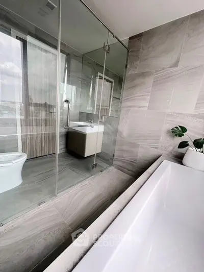 Luxurious modern bathroom with glass shower and elegant bathtub