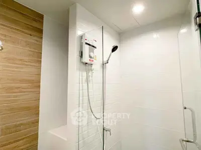 Modern bathroom with sleek shower design and wood accent wall