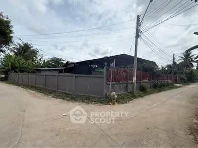 Corner property with fenced yard and lush greenery, ideal for privacy and tranquility seekers.