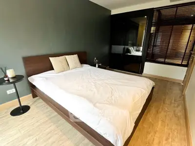 Modern bedroom with sleek wooden flooring and stylish decor