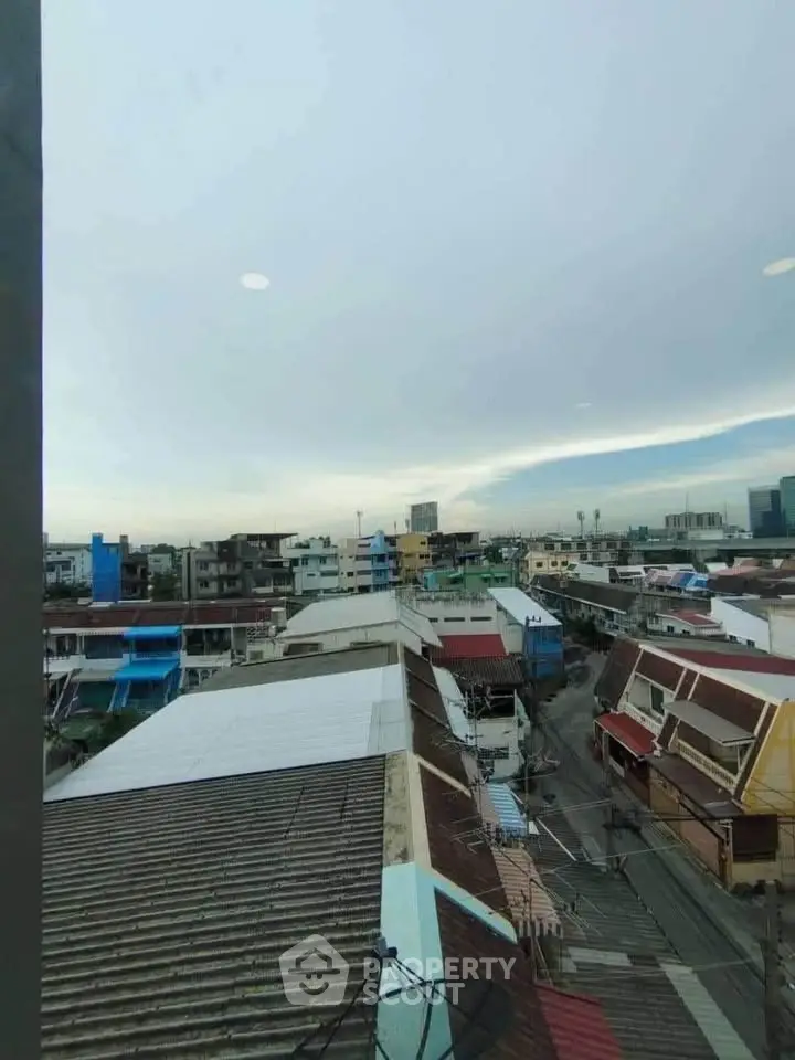 Panoramic cityscape view from a high-rise building window showcasing urban architecture.