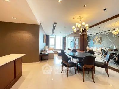 Luxurious dining area with elegant chandelier and mirrored wall in modern apartment
