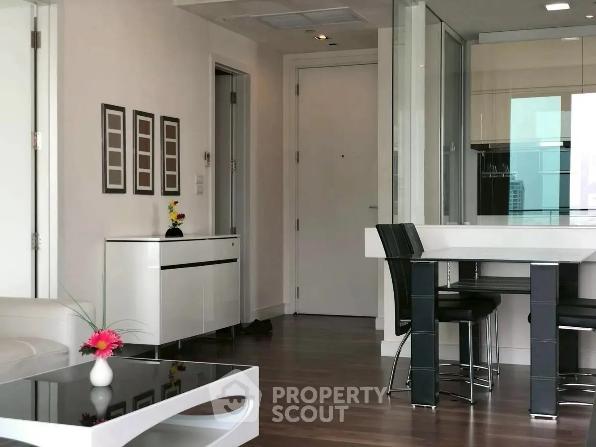 Modern living room with sleek furniture and open kitchen layout