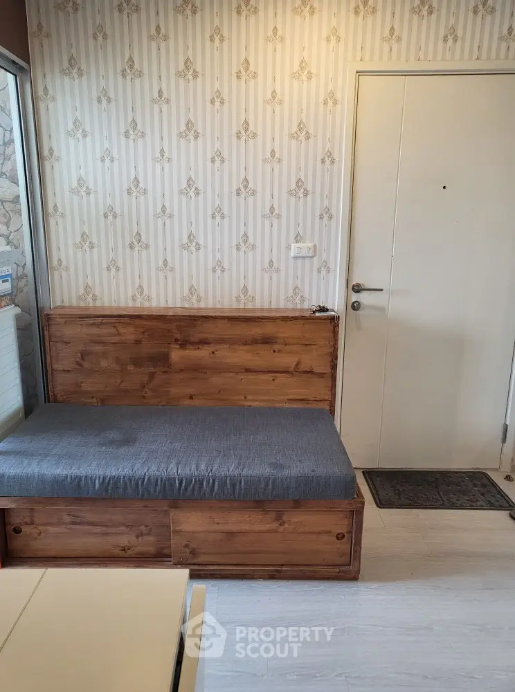 Cozy entryway with wooden bench and stylish wallpaper