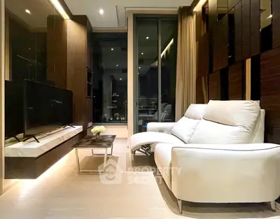 Luxurious modern living room with sleek design and large TV, perfect for relaxation.