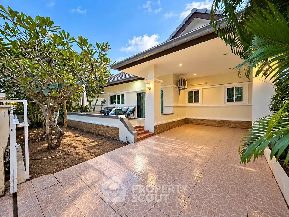 Charming single-story home with spacious patio and lush garden, perfect for outdoor living.
