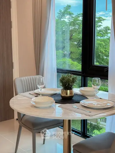 Elegant dining area with round table and window view in modern apartment