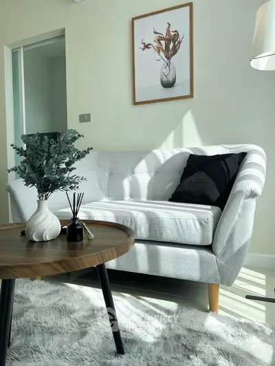 Chic modern living room with stylish sofa, elegant decor, and natural light creating a cozy ambiance.