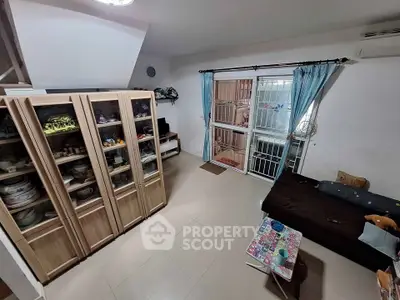 Cozy living room with glass cabinets and sliding door to balcony