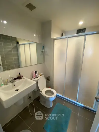 Modern bathroom with sleek fixtures and spacious shower area