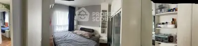 Cozy bedroom with modern furnishings and ample natural light, perfect for relaxation and comfort.