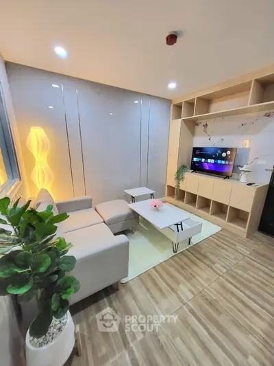 Modern living room with stylish furniture and built-in TV unit, perfect for relaxation.