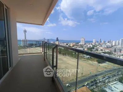 Stunning high-rise balcony with panoramic city and ocean views, perfect for urban living.