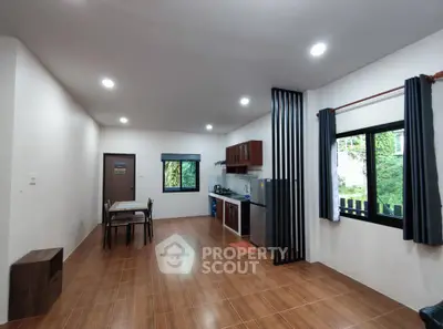 Spacious open-layout kitchen and dining area with modern appliances and natural light.