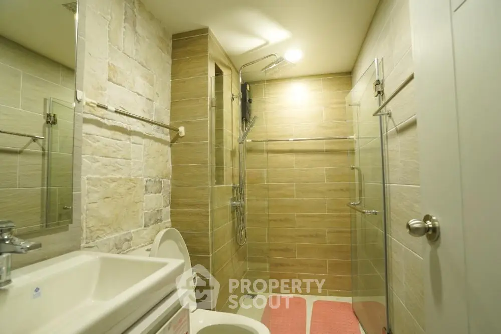 Modern bathroom with glass shower and stylish tile design