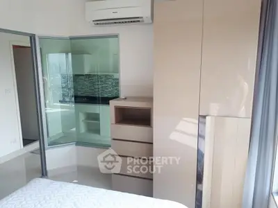 Modern bedroom with sleek design and city view through glass partition