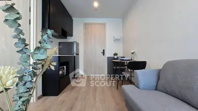 Modern living room with sleek furniture and open kitchen layout