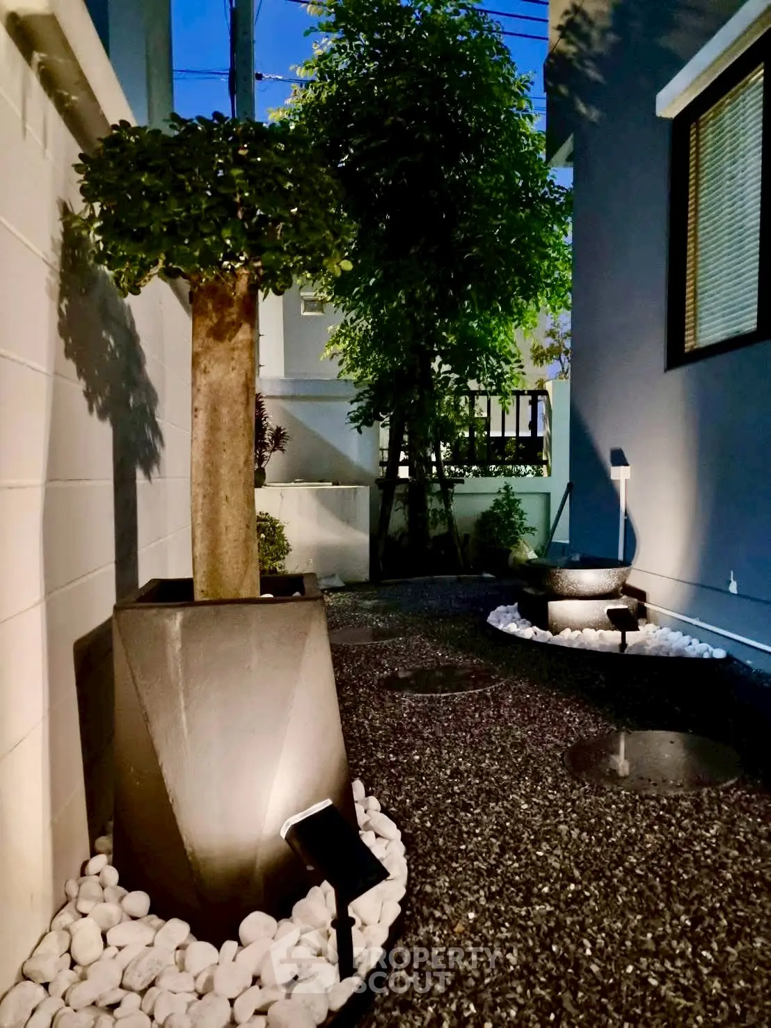 Charming exterior garden with modern lighting and elegant landscaping